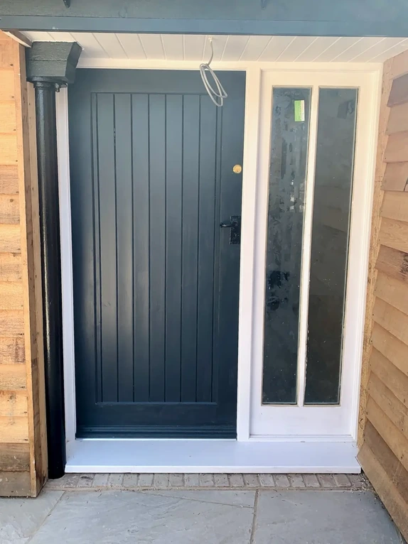 Custom built solid wood front entry doorset featuring an integrated full height glass sidelight window