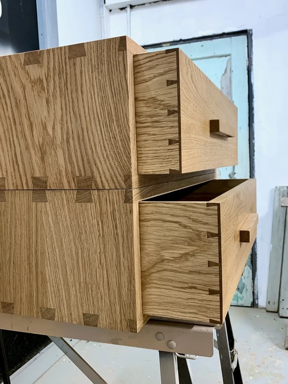 Handcrafted custom bedside drawer units highlighting traditional exposed dovetail joinery construction