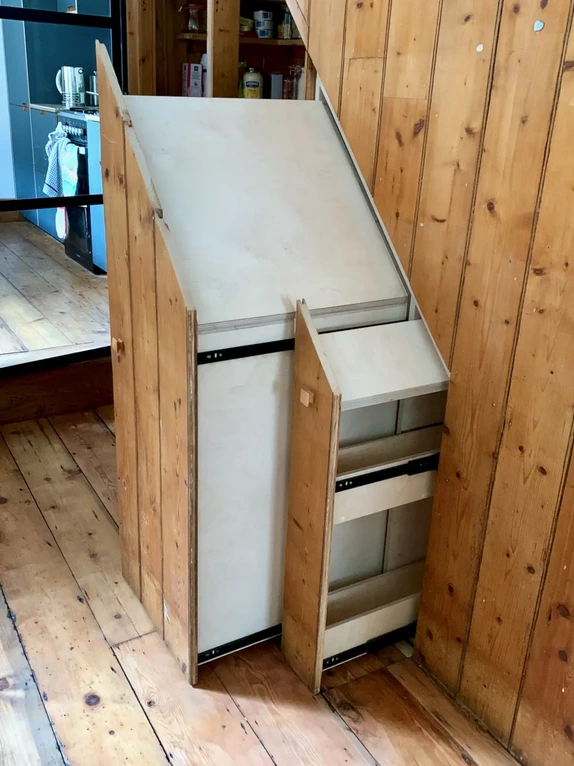 Seamless hidden understairs pull-out storage drawers matching the original timber wall paneling