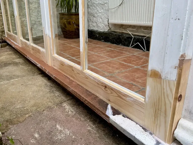 Detailed structural timber frame joinery repair and glass conservatory window restoration work
