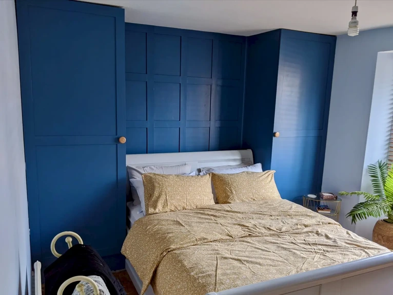 Custom fitted bedroom wardrobes with floor-to-ceiling handmade doors