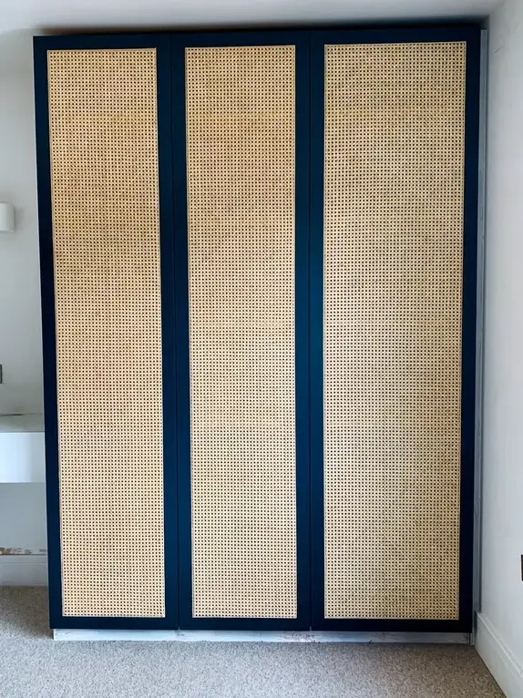 Bespoke fitted bedroom wardrobes featuring traditionally fitted rattan door panels