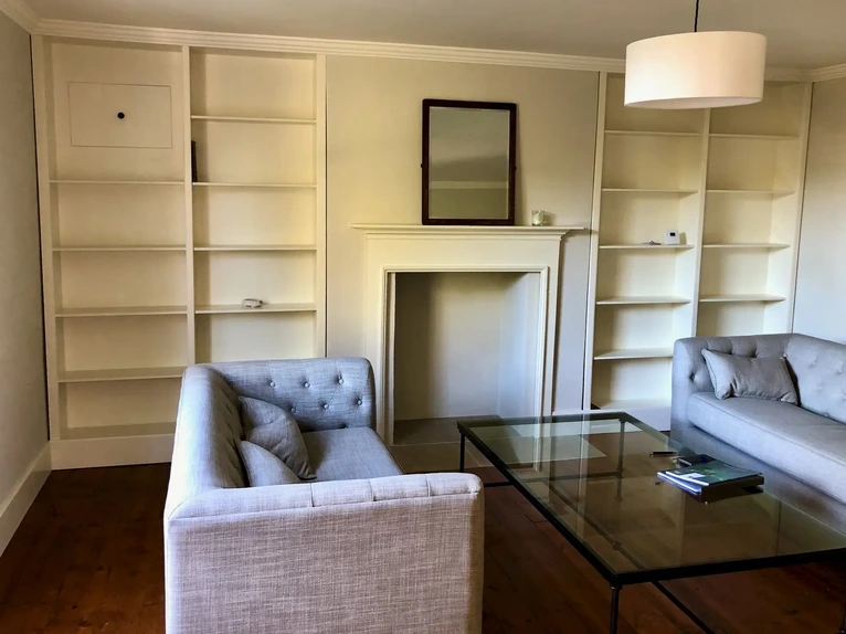 Bespoke solid wood built-in shelving unit fitted into alcove spaces